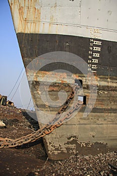 Shipbreaking Yard in Darukhana, Mumbai, India Ã¢â¬â INS Vikrant dismantling with scrap metal & workers in background photo