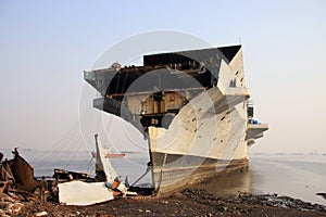 Shipbreaking Yard in Darukhana, Mumbai, India â€“ INS Vikrant dismantling with scrap metal & workers in background