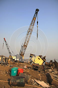 Shipbreaking Yard in Darukhana, Mumbai, India â€“ INS Vikrant dismantling with scrap metal & workers in background