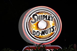 Shipley Donut neon sign lit up at night.