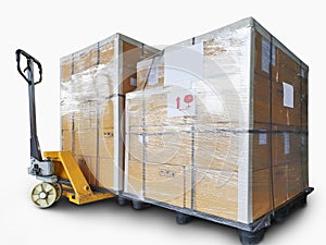 Shipment. Cargo export. Stacked of cardboard boxes on plastic pallets isolated on a white background. Hand pallet truck .