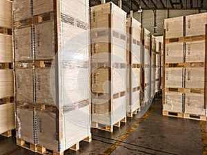 Shipment cartons box on pallets and wooden case on forklift in interior warehouse cargo for export and sorting goods in freight