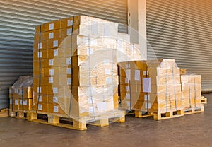 Shipment cartons box on pallets and wooden case on forklift in interior warehouse cargo for export and sorting goods in freight