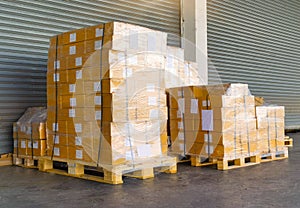 Shipment cartons box on pallets and wooden case on hand lift in interior warehouse cargo for export and sorting goods in freight