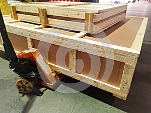 Shipment cartons box on pallets and wooden case on hand lift in interior warehouse cargo for export and sorting goods in freight l