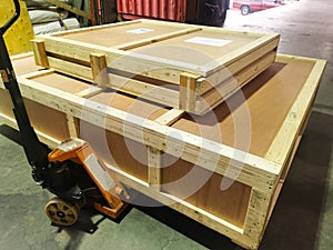 Shipment cartons box on pallets and wooden case on hand lift in interior warehouse cargo for export and sorting goods in freight l