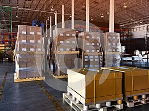 Shipment cartons box on pallets and wooden case on hand lift in interior warehouse cargo for export and sorting goods in freight l