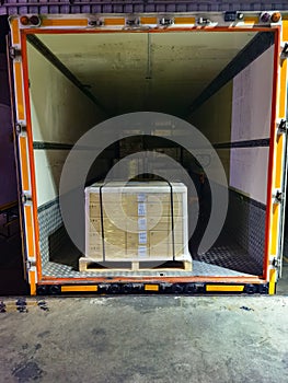 Shipment cartons box on pallets and wooden case on hand lift in interior warehouse cargo for export and sorting goods in freight