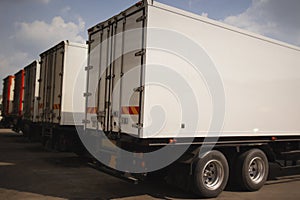 Shipping Cargo Containers. Semi Trailer Trucks on Parking. Shipping Truck. Delivery Transit. Freight Trucks Logistics Transport.