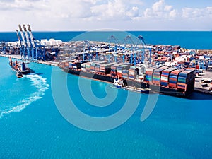 Shipping cargo port to harbor by crane. Container ship business logistics. Water International transport. Aerial top