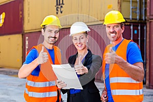 Shipping company workers in front of containers