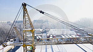 Shipping container and cargo crane at storage yard at winter time aerial view