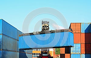 Shipping container loading by richtracker at International ship logistic terminal. Cargo sea containers in warehouse port.