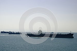 Shipping container vessels, ship convoy aproaching harbor