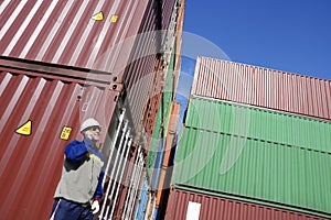 Shipping containers and dock worker photo