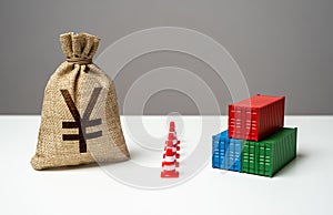 Shipping containers with goods and chinese yuan or japanese yen money bag are separated by a barrier.