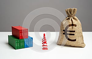 Shipping containers with goods and euro money bag are separated by a barrier.