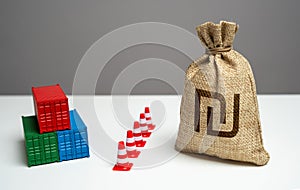 Shipping containers with goods and Israeli shekel money bag are separated by a barrier