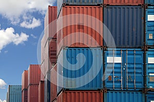 Shipping Containers placed as layered in the storage facility on blue sky background