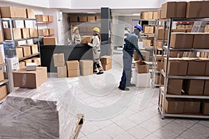 Shipping department employees picking parcels for delivery