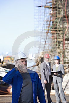 A shipping engineer talking on phone