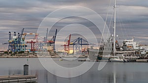 shipping, logistics port harbor cranes working loading transport ships