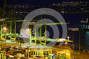 Shipping port with crane for container uploading at night