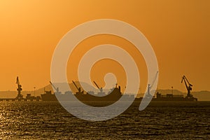 Shipping port in the sea with sunset sky