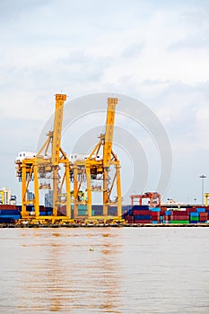 Shipping trade port. Container cargo ship loading or unloading by crane bridge.