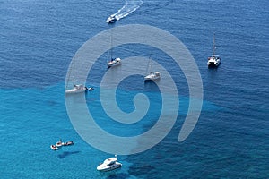 Ships anchored off the coast on the blue calm sea