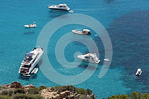 Ships anchored off the coast on the blue calm sea