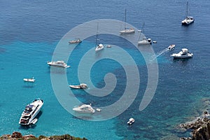 Ships anchored off the coast on the blue calm sea