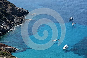 Ships anchored off the coast on the blue calm sea