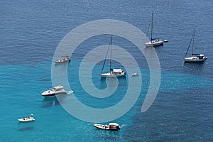 Ships anchored off the coast on the blue calm sea