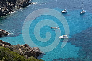 Ships anchored off the coast on the blue calm sea