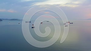 The ships are anchored in the roadstead. Panoramic view from a drone at sunset