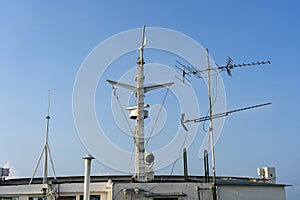 Ships antenna and navigation system on a ferry boat with sunlight and blue sky in background, Thailand