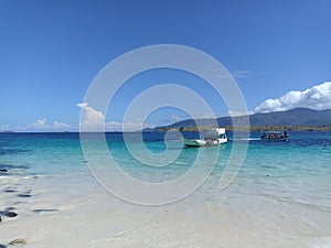 Ships and beautiful beach under blue sky