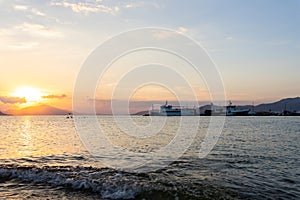 Ships and boats in harbour at sunset at the Greek island of Evia