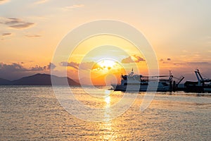 Ships and boats in harbour at sunset at the Greek island of Evia