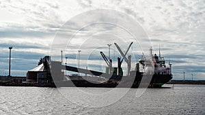 Finnish ship in the cargo port during cargo operation. Ship working on gasoil photo