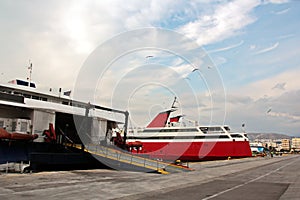 SHIPS AND FERRY AT THE PARKING PORT AT THE SUNSET.