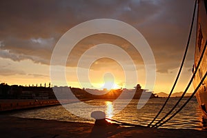 SHIPS AND FERRY AT THE PARKING PORT AT THE SUNSET.