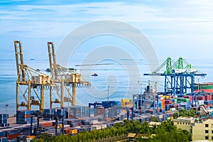 Ships in harbor - giant freighters in port being loaded with containers