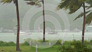 Ships in a harbor under a heavy rain and storm wind. Tropical storm concept. Contains natural sound