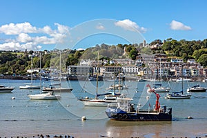 Ships moored in Dartmouth harbour with Britannia Royal Naval College in the background, Devon, England,