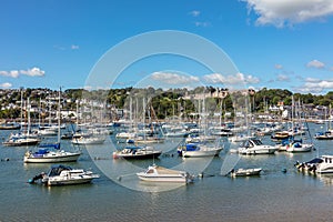 Ships moored in Dartmouth harbour with Britannia Royal Naval College in the background, Devon, England, UK