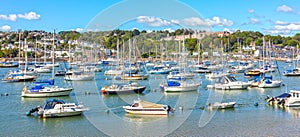 Ships moored in Dartmouth harbour with Britannia Royal Naval College in the background, Devon, United Kingdom