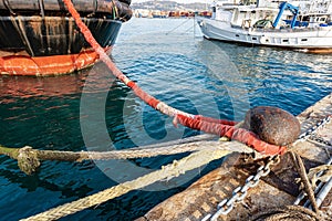 Large mooring bollard with hawsers in the port - La Spezia Italy