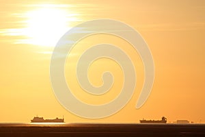 Ships in Morecambe Bay, England at sunset.